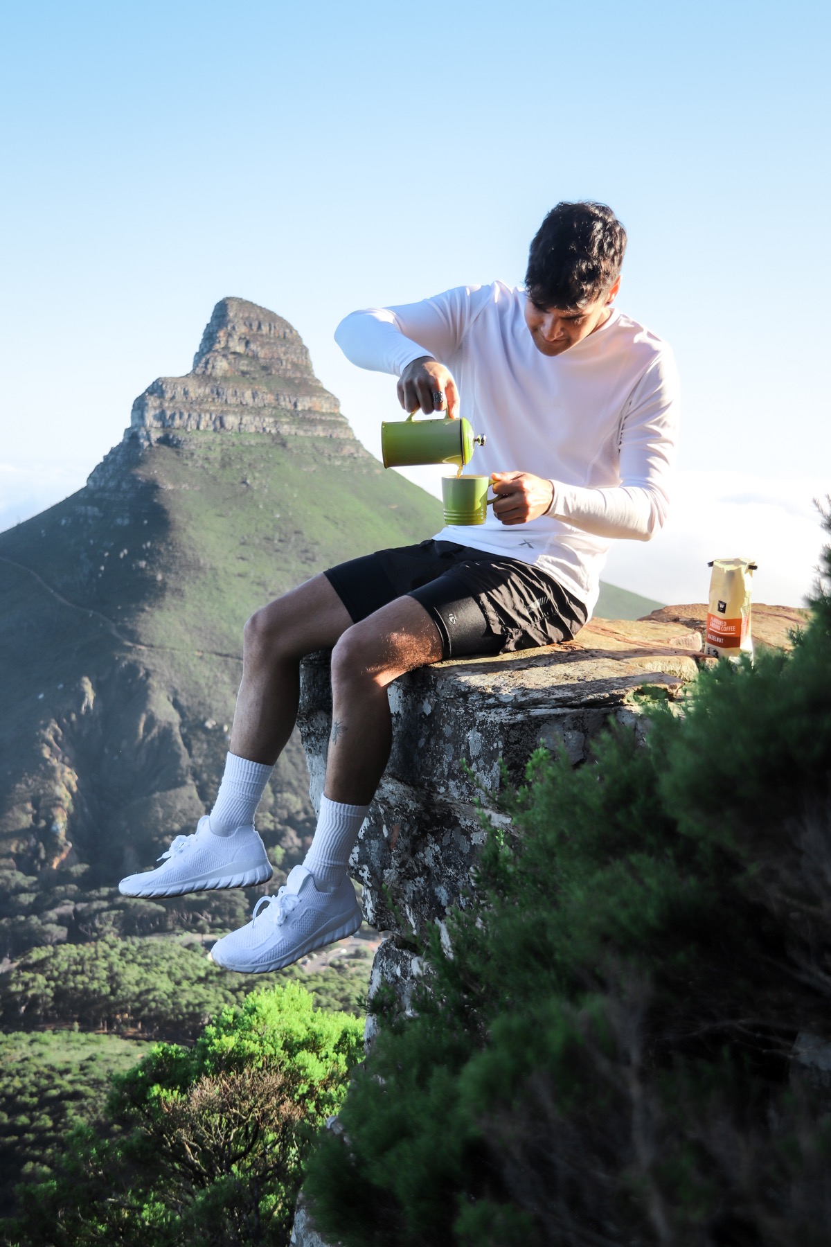 Coffee content on Lion's Head with mountain views.